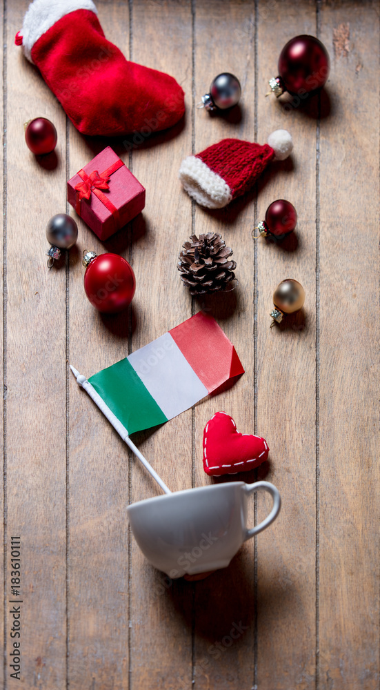 White cup and Italy flag with Christmas decoration White cup and Italy flag with Christmas decoration