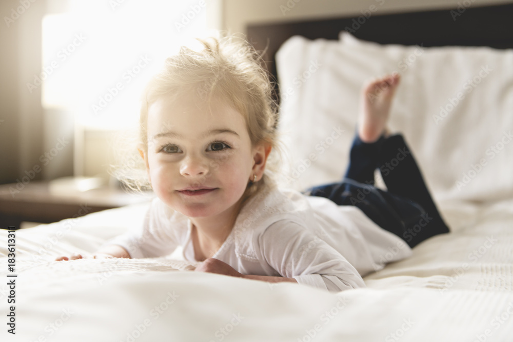 young daughter two years old relaxing in bed, positive feelings young daughter two years old relaxing in bed, positive feelings