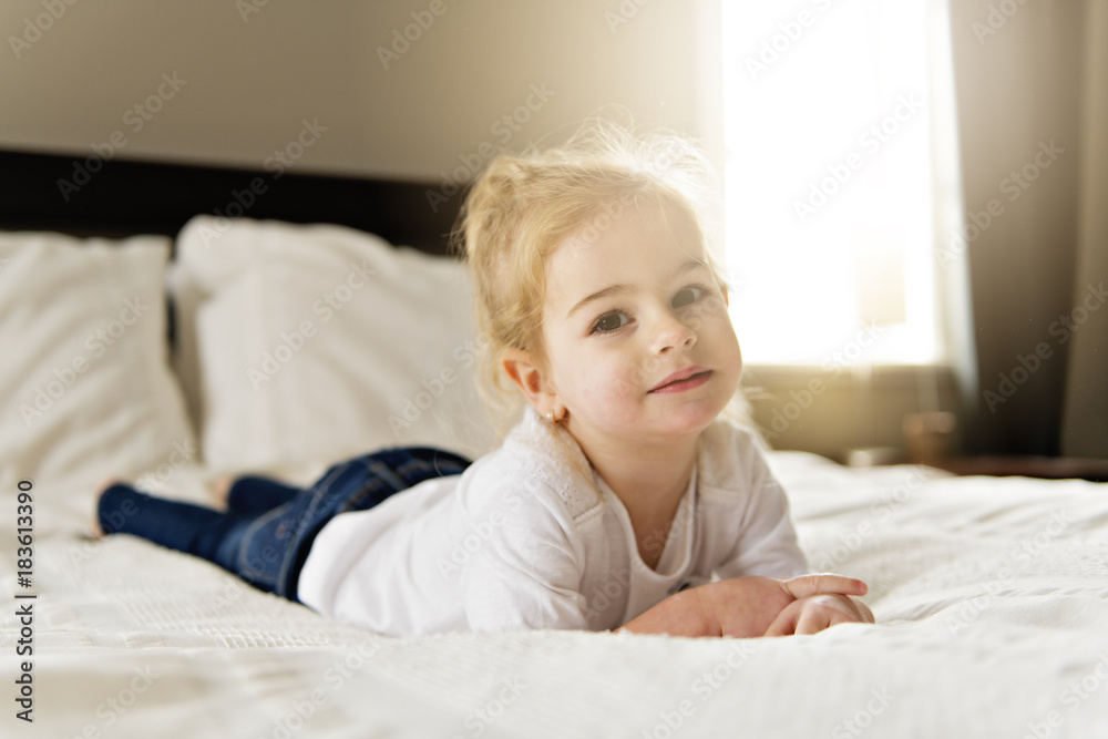 young daughter two years old relaxing in bed, positive feelings young daughter two years old relaxing in bed, positive feelings