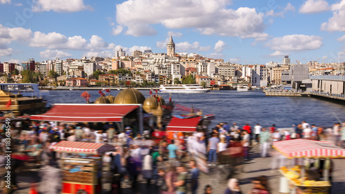 Canvas Print people walking around famoust tourist place in Istanbul with Galata Tower view a