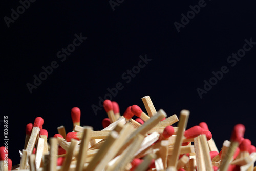 Pile of matches and black background photo