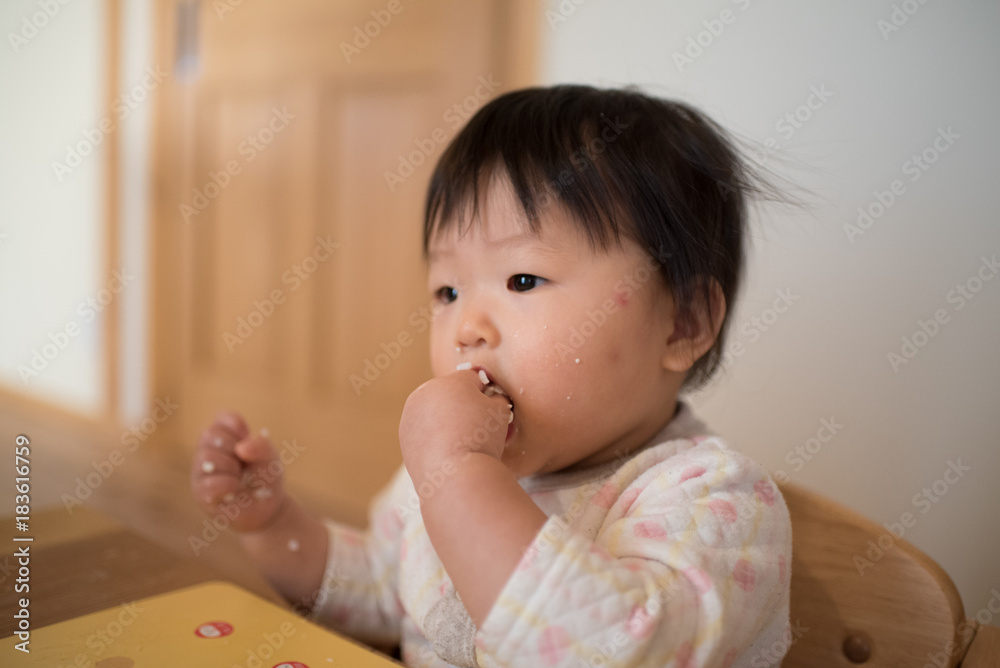 Baby Eating rice by hand / A Japanese girl who is 11 months old Stock Photo  | Adobe Stock