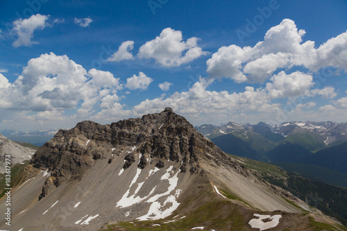 peak of Valbellahorn, blue sky, white clouds photo