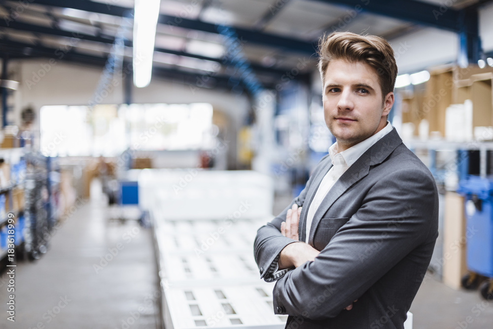 Young manager standing in shop floor, portrait Young manager standing in shop floor, portrait