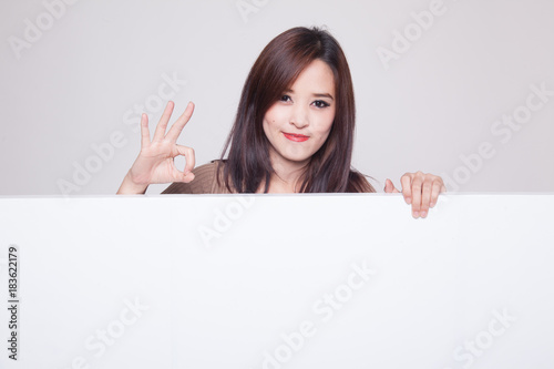 Young Asian woman show OK with blank sign.