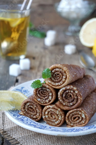 Russian pancakes wrapped in rolls. Traditional carnival meal.