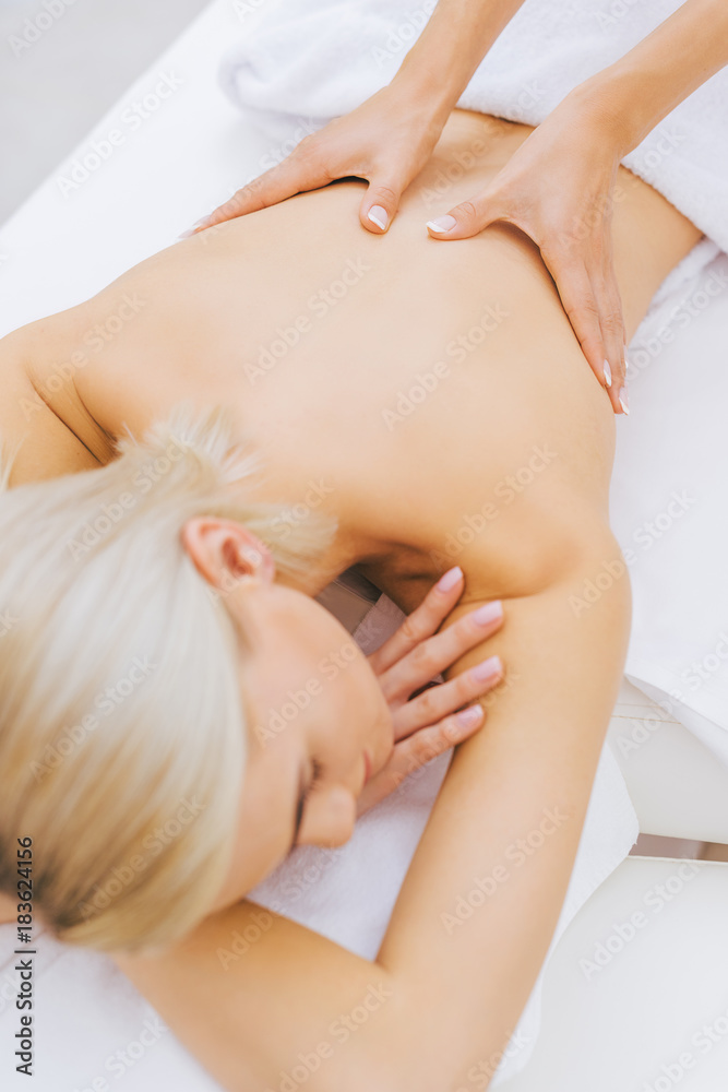 high angle view of beautiful young woman getting massage high angle view of beautiful young woman getting massage