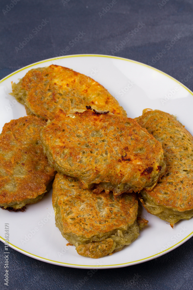 Potato Pancakes. Vegetable fritters. Latkes on a plate Potato Pancakes. Vegetable fritters. Latkes on a plate