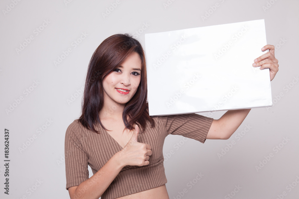 Young Asian woman show thumbs up with white blank sign. Young Asian woman show thumbs up with white blank sign.
