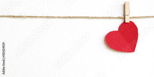Red fabric heart shape hanging on white background, banner, template greeting card valentine celebration concept
