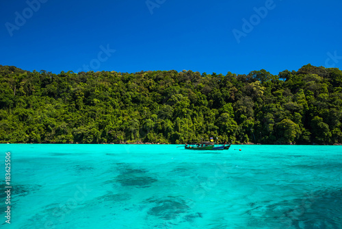 Fototapeta Naklejka Na Ścianę i Meble -  Blue and bright sea water surface at the open sea, Beautiful blue sea at Surin island, Thailand