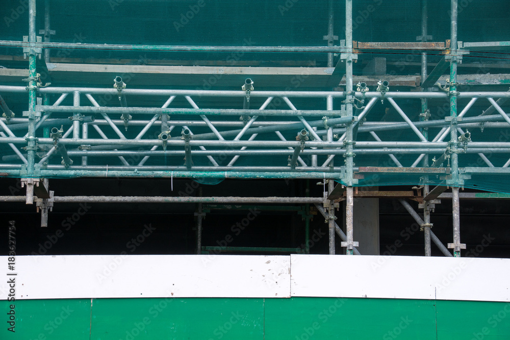 Scaffolding covered with safety net.