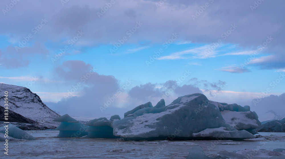 Blue iceberg in frozen lagoon, Fjallsárlón Iceland