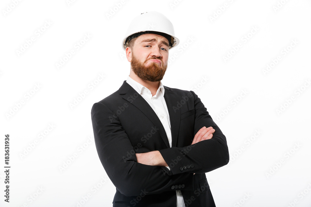 Cool bearded business man in protective helmet holding crossed arms Cool bearded business man in protective helmet holding crossed arms