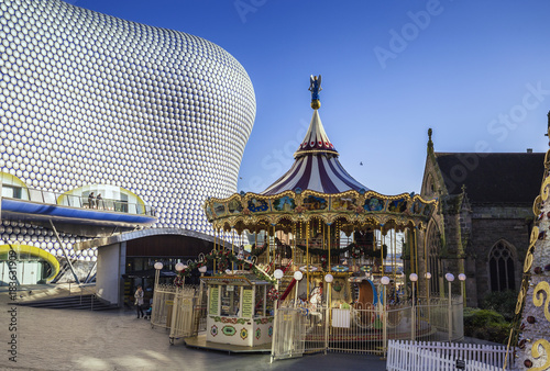 Vintage Christmas Carousel with Modern Building in Background photo