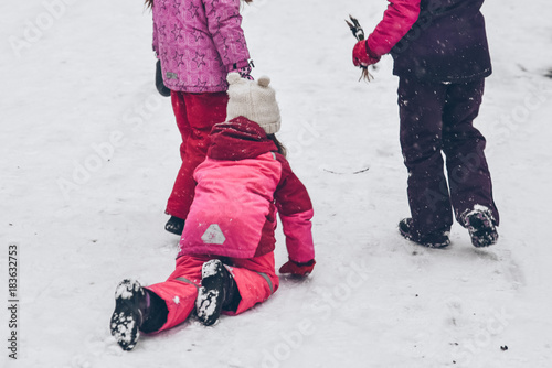 group of kids playing outside in winter day photo