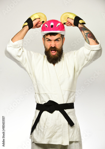 Martial arts. Man with beard in kimono and pink helmet
