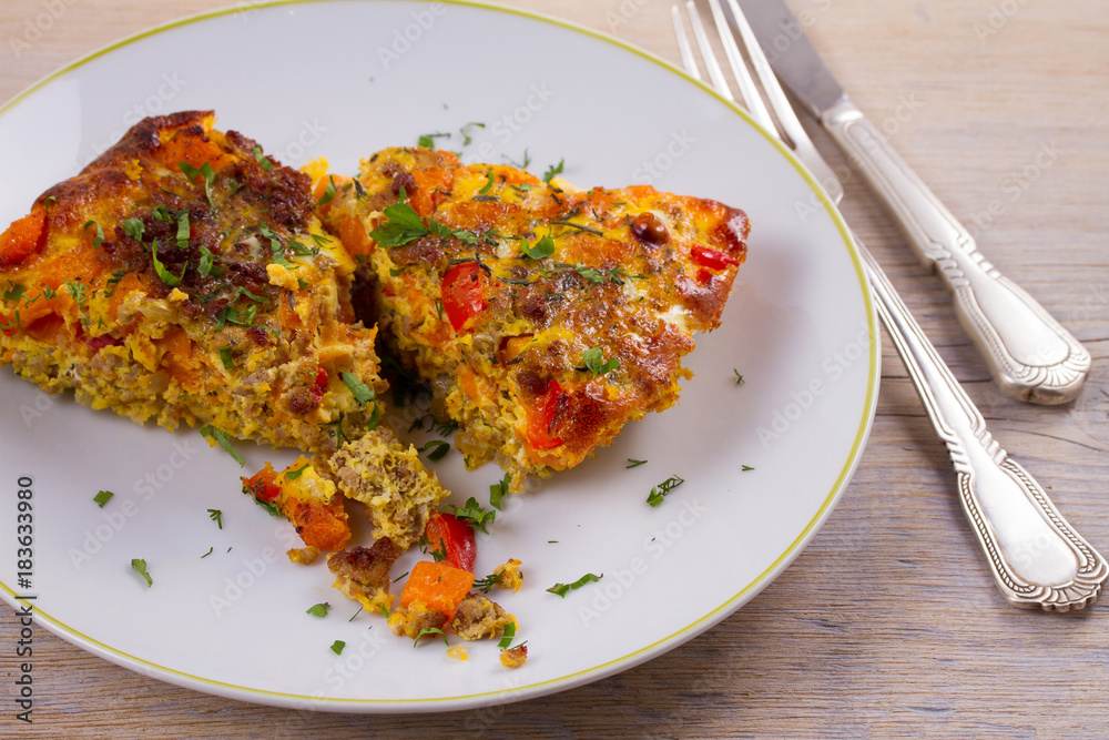 Frittata made with eggs, beef sausage, pumpkin (or butternut squash) and red bell pepper, horizontal Frittata made with eggs, beef sausage, pumpkin (or butternut squash) and red bell pepper, horizontal