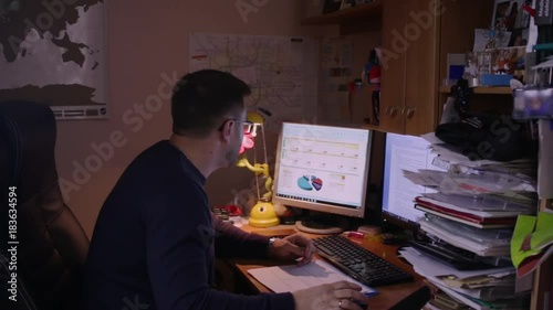 Man working at home office with graphics photo