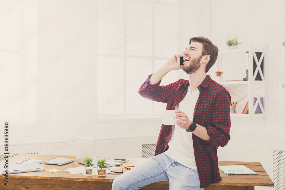 Young concentrated businessman read documents in modern white office Young concentrated businessman read documents in modern white office