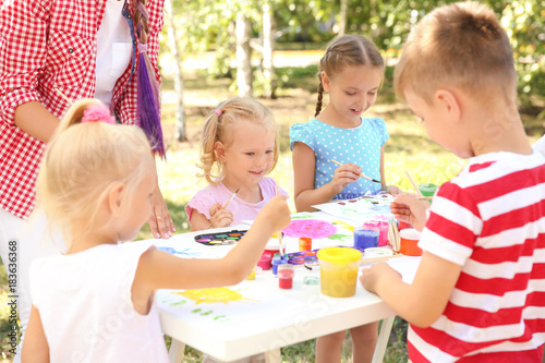 Children at painting lesson outdoors