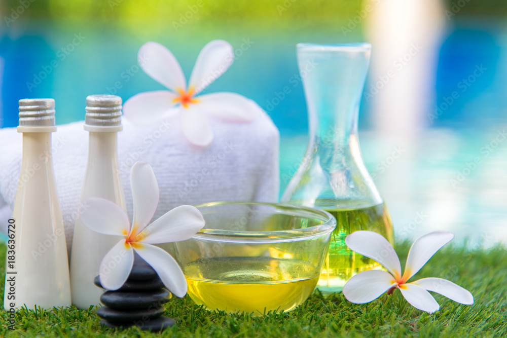 Spa Thai setting for aroma therapy and sugar and salt massage with Plumeria flowers near swimming pool, relax and healthy care.  Healthy Concept, select focus.