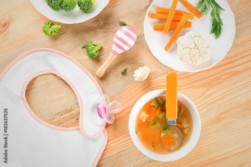 Breakfast with plate of tasty soup for baby on table Breakfast with plate of tasty soup for baby on table