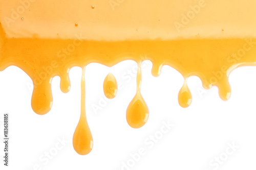 Sweet honey flowing on white background