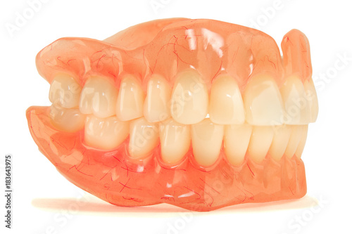 plastic full removable denture of human teeth closeup isolate on white background