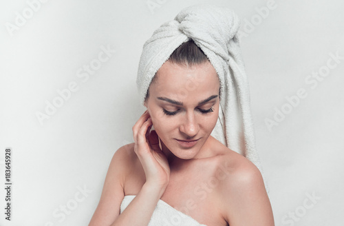 The girl wrapped herself in a white towel. After bath. Facial care