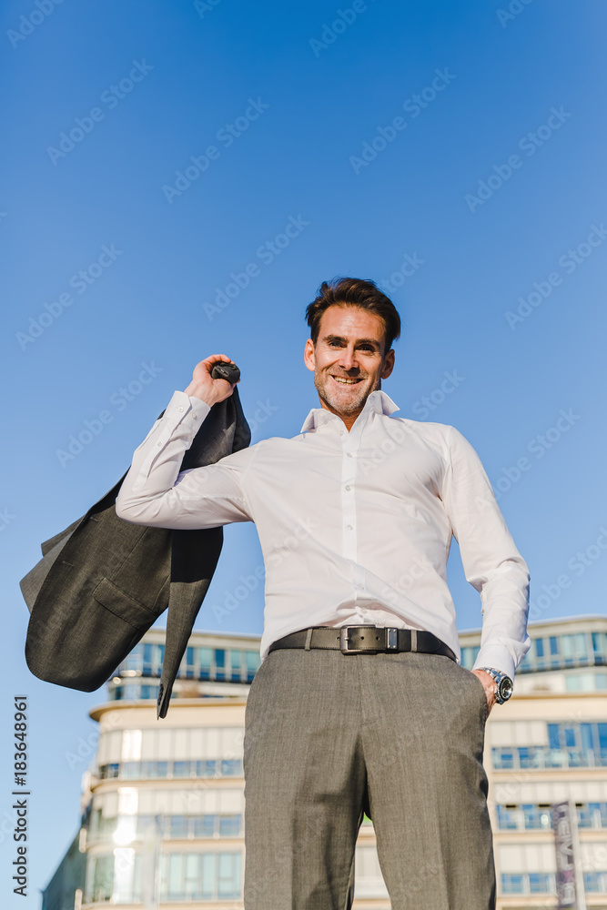 businessman throws his jacket over the shoulder businessman throws his jacket over the shoulder