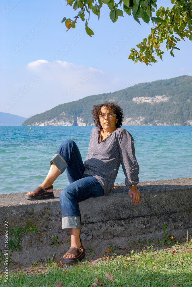 Fototapeta premium mature brunette woman, lake background