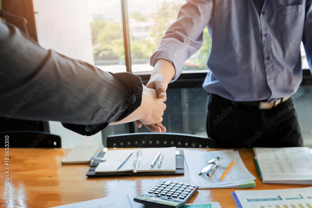 Business people shaking hands finishing up a meeting. Two confident businessman shaking hands during a meeting in the office, success, dealing, greeting and partner concept. Business people shaking hands finishing up a meeting. Two confident businessman shaking hands during a meeting in the office, success, dealing, greeting and partner concept.