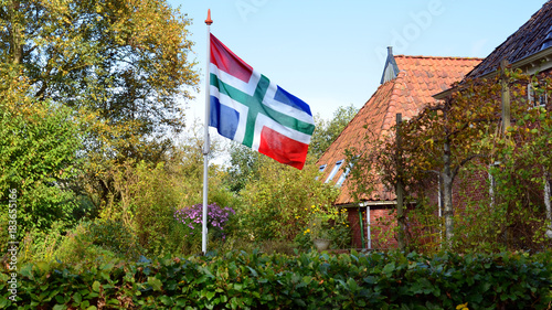 Flag of the province of Groningen in peasant garden photo