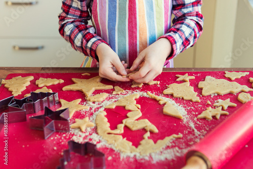 Close up of childs hands making christmas cookies