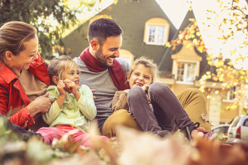Smiling family have fun at backyard.