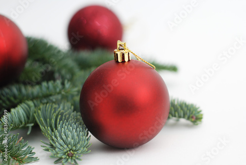 A red Christmas Tree Bauble Decoration Ornament with a red ribbon bow