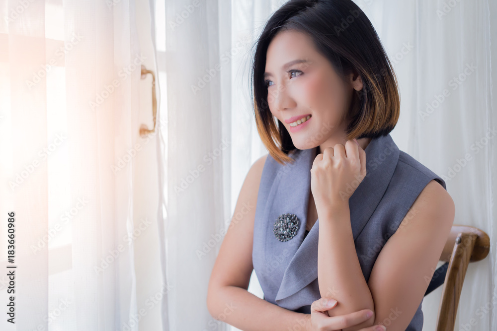 smart asian woman in working dress in thinking somthing next to white curtain wndow smart asian woman in working dress in thinking somthing next to white curtain wndow