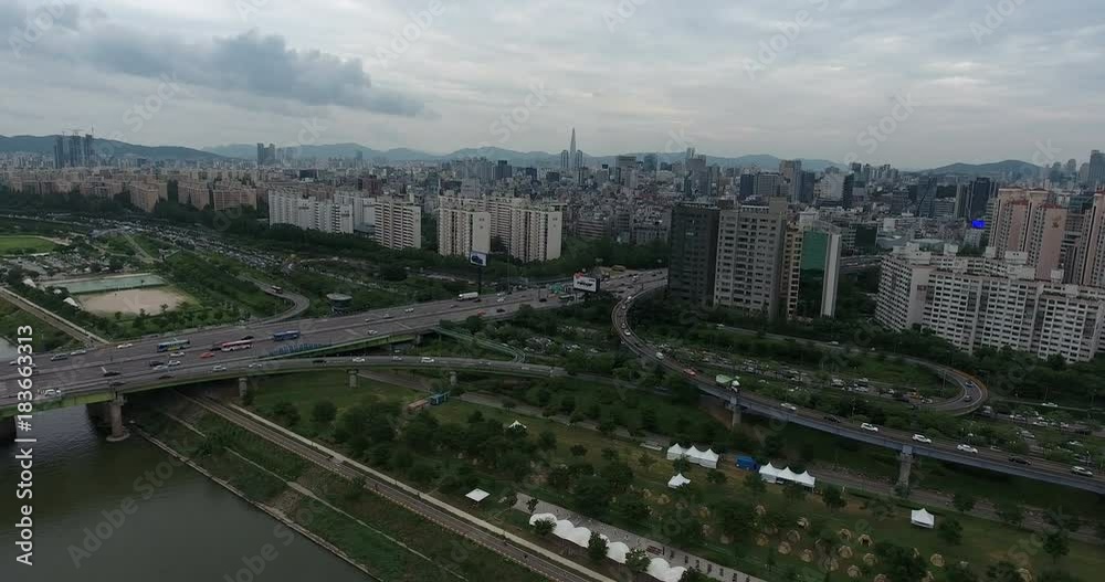 SEOUL, SOUTH KOREA – JULY 216 : Aerial shot over Han River on a cloudy day with traffic and cityscape in view SEOUL, SOUTH KOREA – JULY 216 : Aerial shot over Han River on a cloudy day with traffic and cityscape in view