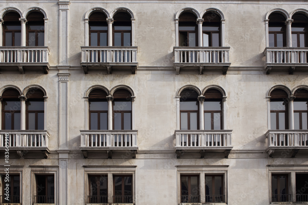 View of a facade of old, historical building in Venice. The image reflects architectural style of region. View of a facade of old, historical building in Venice. The image reflects architectural style of region.