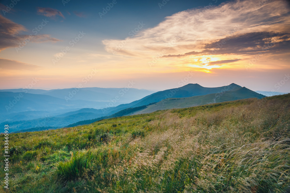 Summer mountain landscape at sunrise with grass and blue sky Summer mountain landscape at sunrise with grass and blue sky