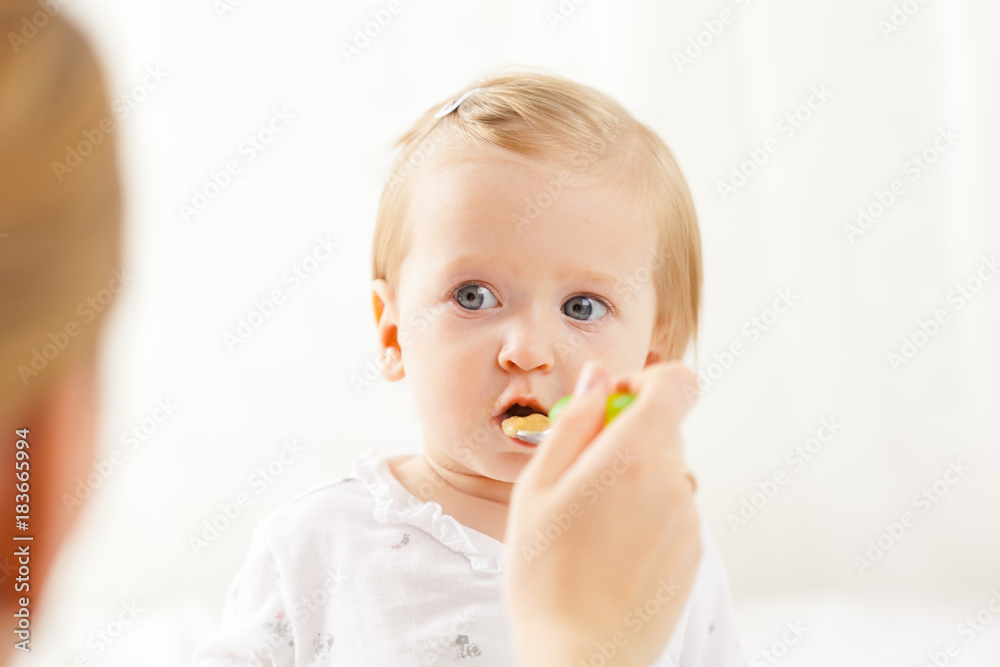 Little baby feeding with a spoon Little baby feeding with a spoon