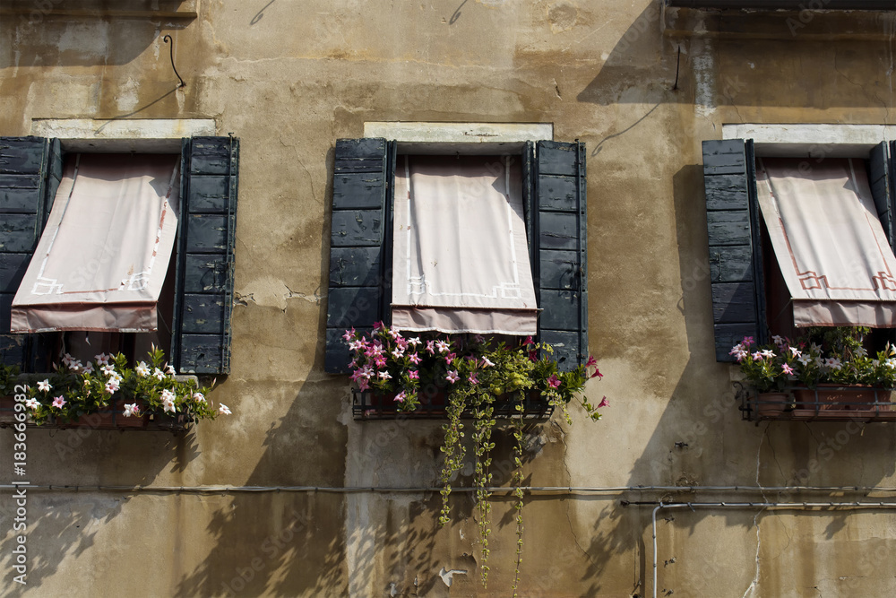 Fototapeta premium Facade view of old, historical, typical building in Venice. Image shows architectural style of region.
