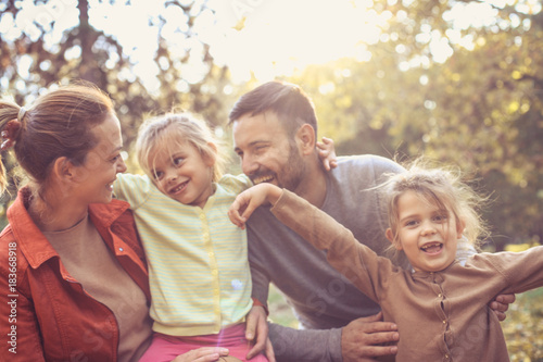 Happy family outside in colorful fall backyard.