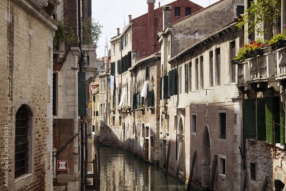 View of hung washed clothes on a old, historical, typical buildings in Venice / Italy. Image shows culture and lifestyle of the region.