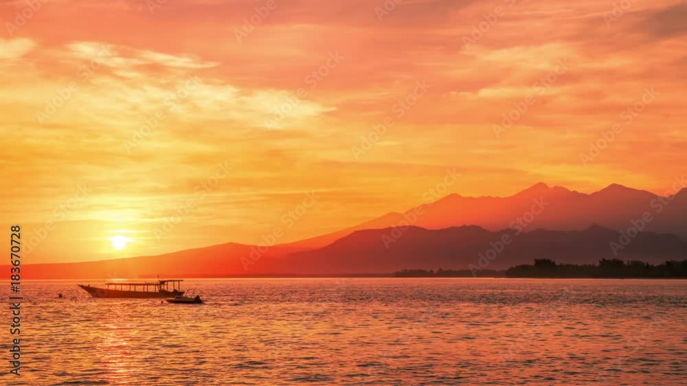 Timelapse Dawn above volcano Rinjani to the island Lombok with boat in Indonesia Timelapse Dawn above volcano Rinjani to the island Lombok with boat in Indonesia