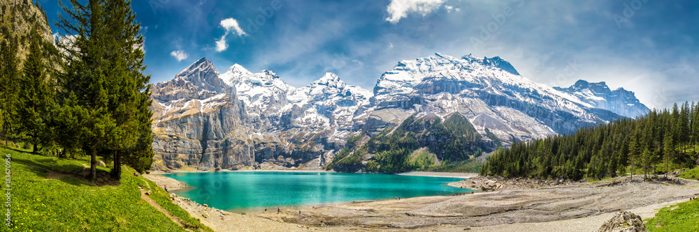 Amazing tourquise Oeschinnensee with waterfalls in Swiss Alps