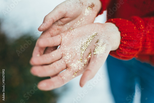 Golden glitter in hands