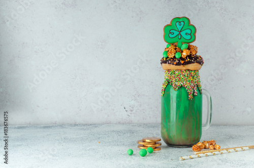 St. Patrick's Day green freak shake topping with clover cookie with copy space