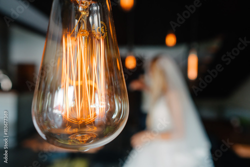retro bulbs lights. newlyweds couple embracing